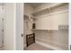 Walk-in closet with shelves, carpet flooring, and a folding cot, offering a practical and organized storage space at 1333 Elati St # 3, Denver, CO 80204