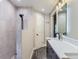 Stylish bathroom featuring a spacious walk-in shower with gray tile and a sleek vanity with modern black fixtures at 7273 Silverhorn Dr, Evergreen, CO 80439