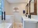 Bright bathroom featuring dual sinks with black fixtures, modern mirrors, and a shower with glass door, well-lit at 7273 Silverhorn Dr, Evergreen, CO 80439