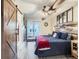 Bedroom with exposed wood beams and sliding door leading to a balcony at 7273 Silverhorn Dr, Evergreen, CO 80439