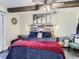 Cozy bedroom featuring wood beam, a king bed with a decorative headboard, and unique side tables at 7273 Silverhorn Dr, Evergreen, CO 80439