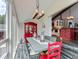 Inviting dining area with a large table, bright lighting, and views into the kitchen and backyard at 7273 Silverhorn Dr, Evergreen, CO 80439