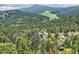 Picturesque mountain home nestled among lush forest, complemented by scenic views and a tranquil setting at 7273 Silverhorn Dr, Evergreen, CO 80439