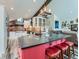 Bright, open kitchen featuring a large island with seating, stainless steel appliances, and adjacent living area for easy entertaining at 7273 Silverhorn Dr, Evergreen, CO 80439