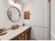 Updated bathroom with modern vanity and large mirror at 14942 E Evans Ave, Aurora, CO 80014