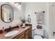 Updated bathroom with granite countertop, oval mirror, and modern fixtures at 14942 E Evans Ave, Aurora, CO 80014