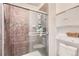 Clean bathroom with tiled shower and built-in shelving at 14942 E Evans Ave, Aurora, CO 80014