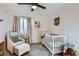 Bright Bedroom with crib, comfortable armchair, and plenty of natural light at 14942 E Evans Ave, Aurora, CO 80014