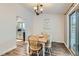 Bright dining room with farmhouse table and kitchen view at 14942 E Evans Ave, Aurora, CO 80014