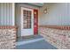 Front entrance with brickwork, a white door and a red frame at 14942 E Evans Ave, Aurora, CO 80014