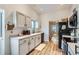 Updated kitchen featuring white cabinets and stainless steel appliances at 14942 E Evans Ave, Aurora, CO 80014