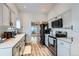 Modern kitchen with white cabinets and stainless steel appliances at 14942 E Evans Ave, Aurora, CO 80014