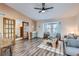 Bright living room features hardwood floors and French doors at 14942 E Evans Ave, Aurora, CO 80014