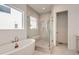 Modern bathroom featuring a soaking tub, walk-in glass shower, and sleek fixtures at 3166 Newfound Lake Rd, Berthoud, CO 80513