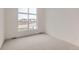 Bright, carpeted bedroom with a large window offering neighborhood views and lots of natural light at 3166 Newfound Lake Rd, Berthoud, CO 80513