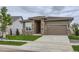 Inviting single-Gathering home featuring a stone-accented facade, lush lawn, and a two-car garage at 3166 Newfound Lake Rd, Berthoud, CO 80513