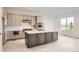 Modern kitchen featuring stainless appliances, a spacious island, and stylish cabinetry at 3166 Newfound Lake Rd, Berthoud, CO 80513
