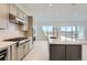 Bright, modern kitchen with stainless steel appliances, center island, and white countertops at 3166 Newfound Lake Rd, Berthoud, CO 80513