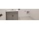 Functional laundry area with a modern gray cabinet, countertop sink, and utility connections at 3166 Newfound Lake Rd, Berthoud, CO 80513