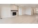 Bright and spacious living room with modern fireplace and light hardwood floors at 3166 Newfound Lake Rd, Berthoud, CO 80513