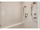 Modern shower featuring dual shower heads, a built-in seat, and sleek, light-colored tile work at 3166 Newfound Lake Rd, Berthoud, CO 80513