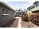 A walkway between gray house and fence is surrounded by landscaping at 1518-1520 S Sherman St, Denver, CO 80210