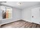 Bedroom with hardwood floors and a window offering a view of the neighborhood at 1518-1520 S Sherman St, Denver, CO 80210
