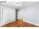 Bedroom featuring hardwood floors and a double-door closet for storage at 1518-1520 S Sherman St, Denver, CO 80210