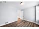 Bedroom with hardwood floors and a view of the hall through a door at 1518-1520 S Sherman St, Denver, CO 80210