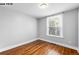 Bedroom featuring hardwood floors and a window providing a view of the neighborhood at 1518-1520 S Sherman St, Denver, CO 80210
