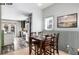 Dining room with a wooden table, seating for four, and a view into the modern kitchen at 1518-1520 S Sherman St, Denver, CO 80210