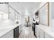 Galley kitchen featuring white cabinets, countertops, a black gas range and a small breakfast nook with seating at 1518-1520 S Sherman St, Denver, CO 80210