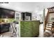 Spacious kitchen with dark cabinets, granite countertops, and a tiled half wall that looks into the living area at 1518-1520 S Sherman St, Denver, CO 80210