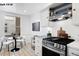 Bright kitchen features updated appliances, blue backsplash, and an adjacent dining area at 1518-1520 S Sherman St, Denver, CO 80210