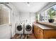 Functional laundry room with modern appliances, counter space, and a bright window offering natural light at 1518-1520 S Sherman St, Denver, CO 80210