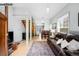 Open-concept living room with a large brown leather sofa, hardwood floors, and an open staircase at 1518-1520 S Sherman St, Denver, CO 80210