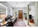 Comfortable living room with a brown leather sofa, wainscoting, and a view of the front door at 1518-1520 S Sherman St, Denver, CO 80210