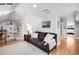Comfortable living area with a plush couch, hardwood floors, and natural light from the surrounding windows at 1518-1520 S Sherman St, Denver, CO 80210