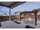 Covered patio with pergola, bar, and seating area in a fenced backyard at 2785 Black Hawk Pl, Brighton, CO 80601