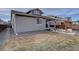Back exterior view showing the patio area with pergola and fenced yard at 2785 Black Hawk Pl, Brighton, CO 80601