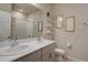 Bright bathroom featuring double sinks, quartz countertop, and a shower-tub combination at 2785 Black Hawk Pl, Brighton, CO 80601
