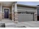 Exterior view of the home showing the garage and front door entrance at 2785 Black Hawk Pl, Brighton, CO 80601