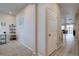 Hallway showcasing a decorative shelf, artwork, and access to different areas of the home at 2785 Black Hawk Pl, Brighton, CO 80601