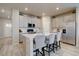 Modern kitchen features stainless steel appliances, white cabinets, and a center island with seating at 2785 Black Hawk Pl, Brighton, CO 80601