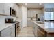 Well-equipped kitchen features stainless steel appliances, modern cabinets, and a large island with a sink at 2785 Black Hawk Pl, Brighton, CO 80601