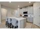 Modern kitchen features stainless steel appliances, white cabinets, and a center island with seating at 2785 Black Hawk Pl, Brighton, CO 80601