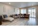 Cozy living room with a large sectional sofa, modern decor, and natural light at 2785 Black Hawk Pl, Brighton, CO 80601