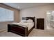 Cozy bedroom with a large bed, neutral décor, and an en-suite bathroom at 2785 Black Hawk Pl, Brighton, CO 80601