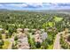 Aerial view of a neighborhood surrounded by lush greenery, a golf course and beautiful trees at 3311 Klondike Pl, Castle Rock, CO 80108