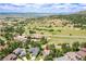 Aerial view of home nestled among trees, showing proximity to open land and mountains at 3311 Klondike Pl, Castle Rock, CO 80108